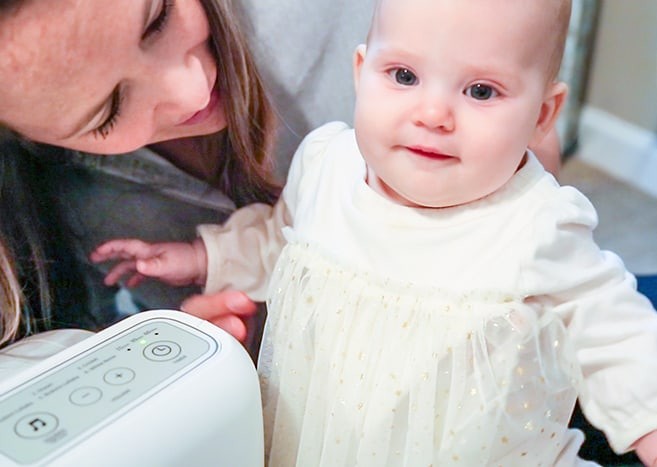 baby and mom with air purifier in nursery