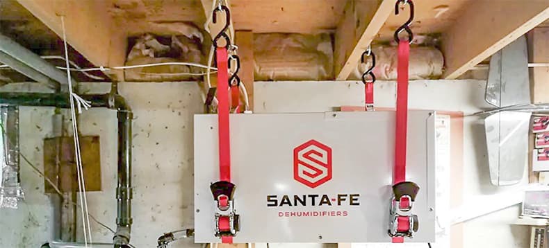 Santa Fe Compact70 dehumidifier suspended from floor joists