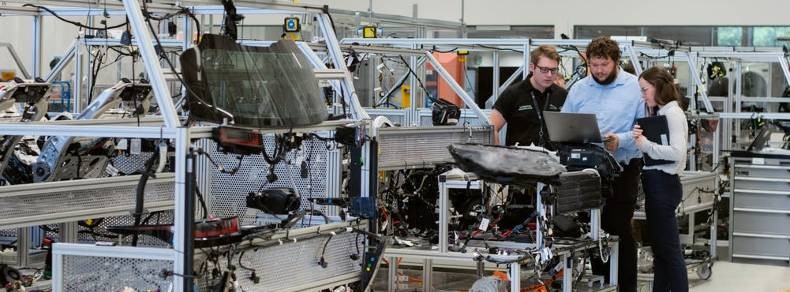 Workers at Work Station In A Factory